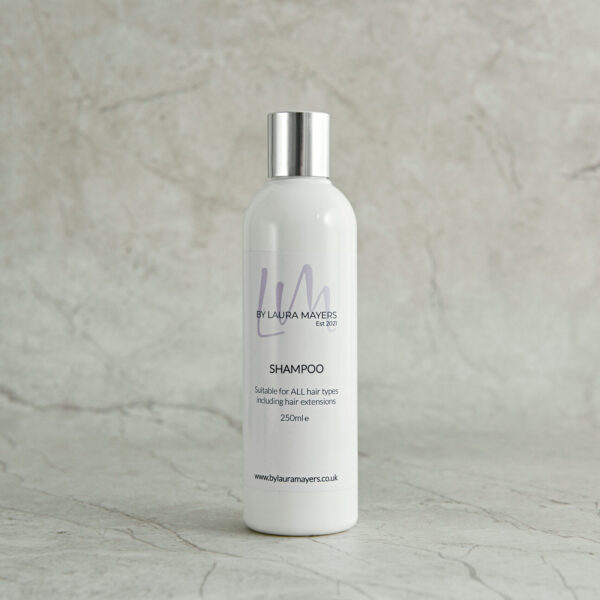 single shot of a bottle of luxury shampoo bylauramayers